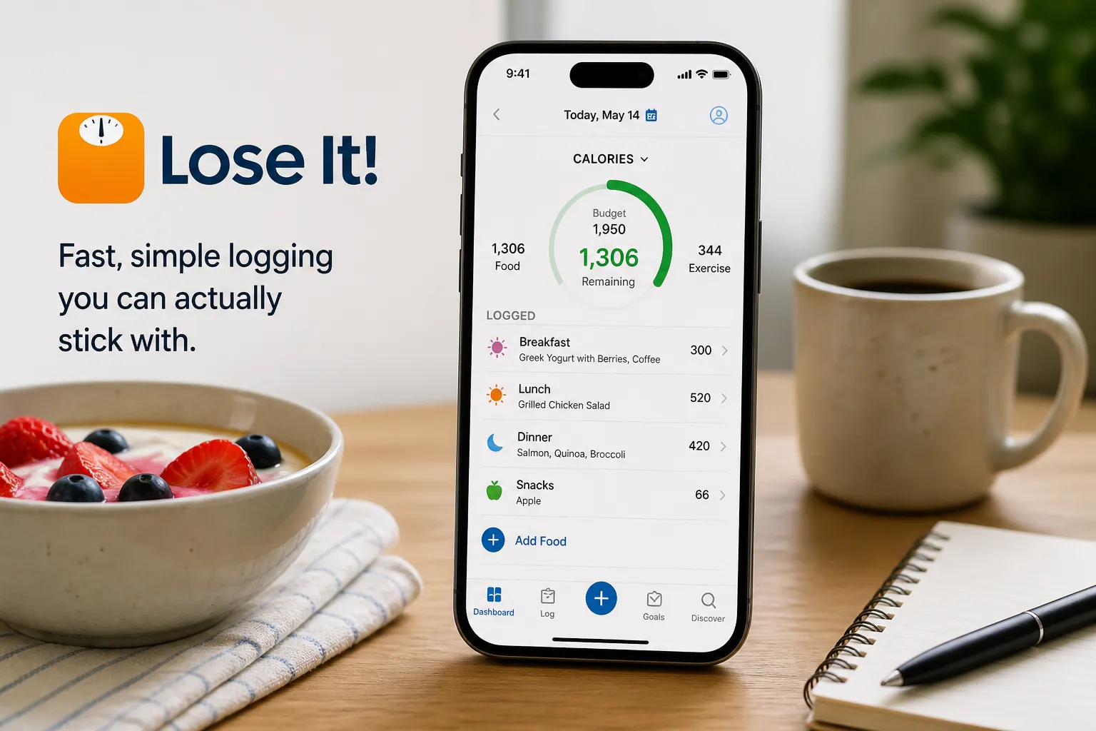 Smartphone showing the Lose It! calorie logging dashboard beside a bowl of fruit and a coffee mug.
